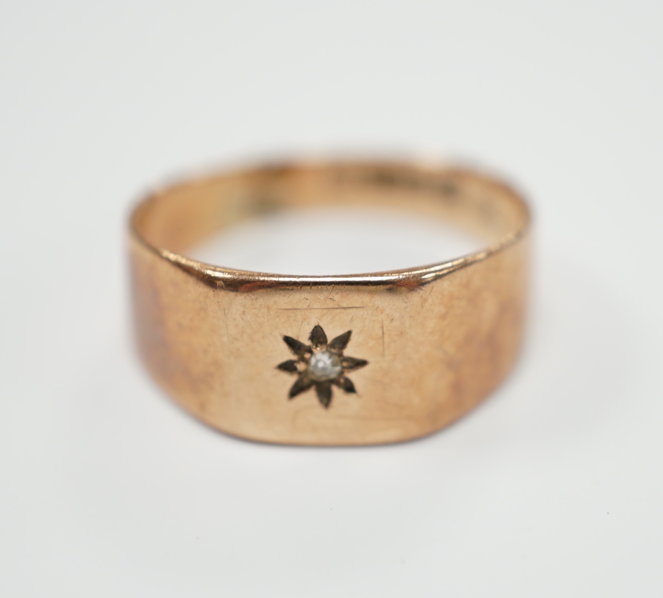 A 9ct gold and diamond chip set signet ring, size R, gross weight 3.7 grams.